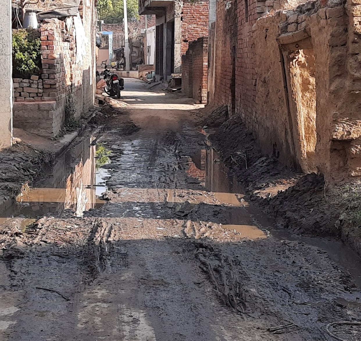 People are disturbed by dirt and mud on the paved road