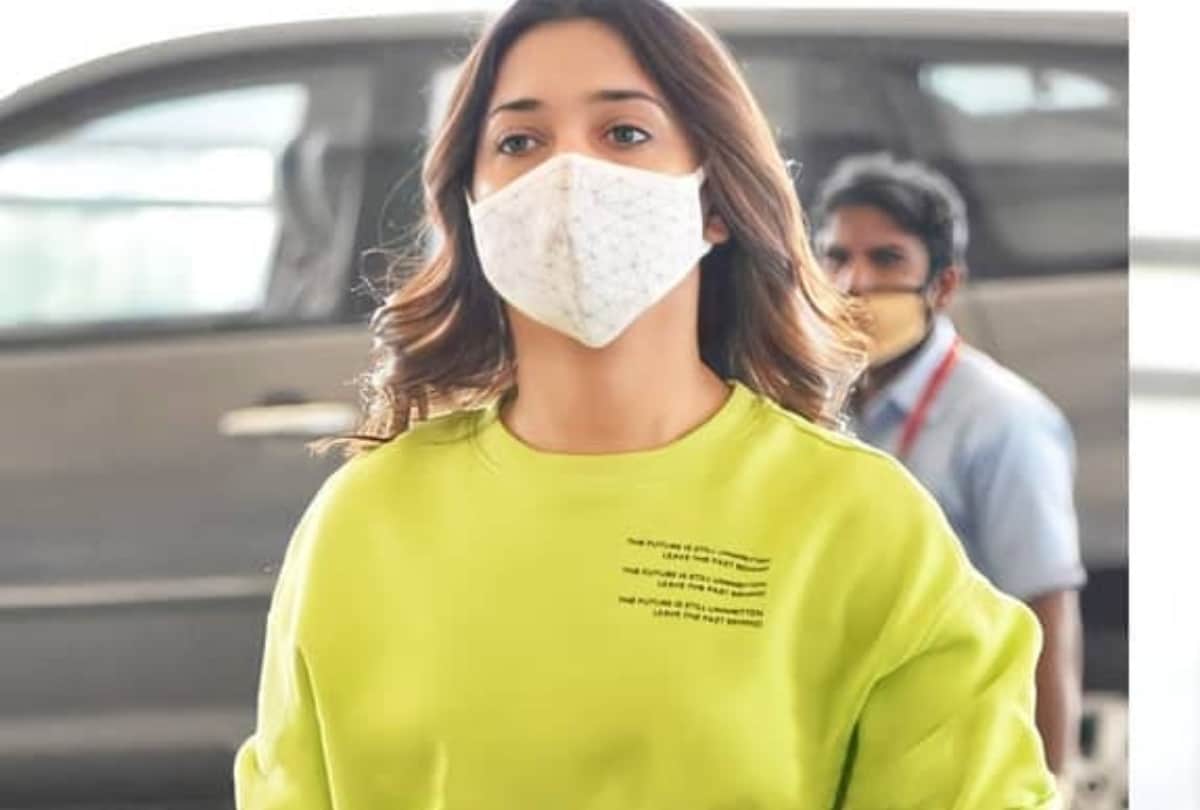tamannaah bhatia shows toned legs in denim hot pants with lime green sweatshirt at airport