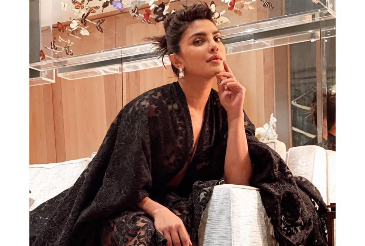 priyanka chopra wearing black baggy dress with plunging neckline