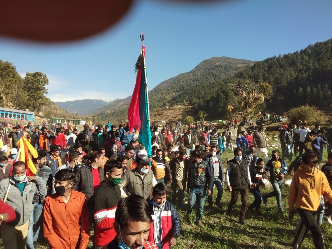Villagers race in the fields with deity for prosperity