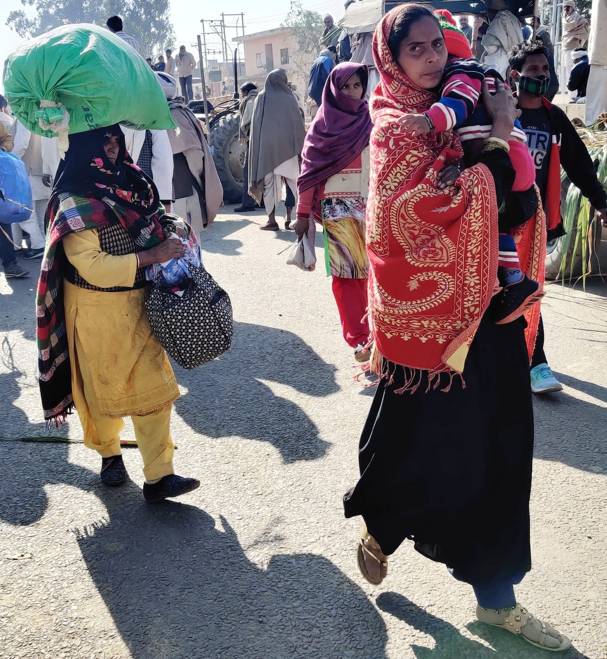 Passenger walking for two km with luggage on his head, children in his lap