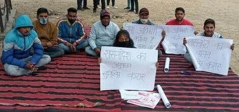 Daughter sitting on dharna with father