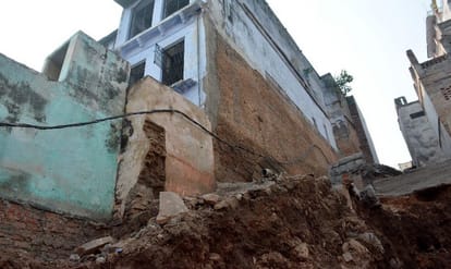 Nepalis people faith center Pashupatinath temple danger walls crushed by the pressure of machines in varanasi