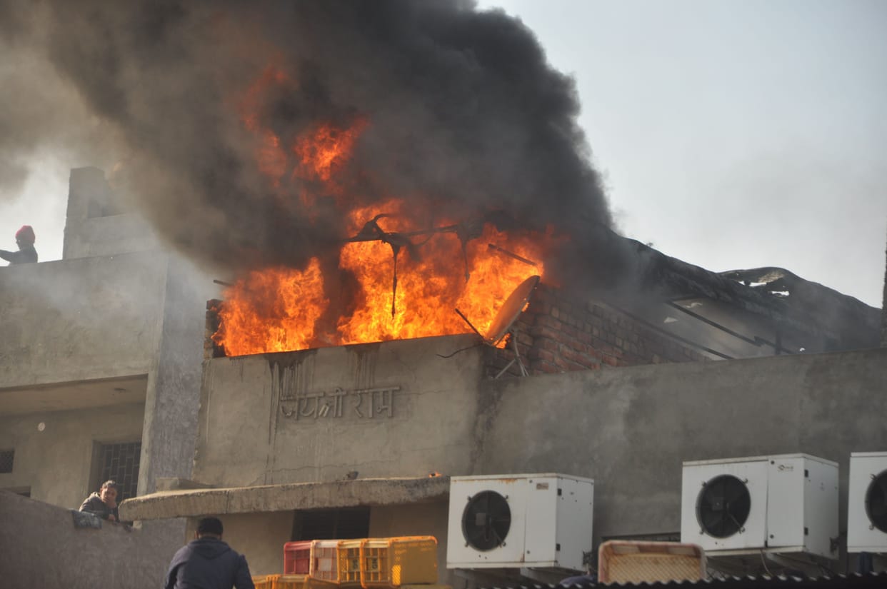 Vegetable Market: A fire in gunny bags, on the roof of a cold store, burns plastic carats