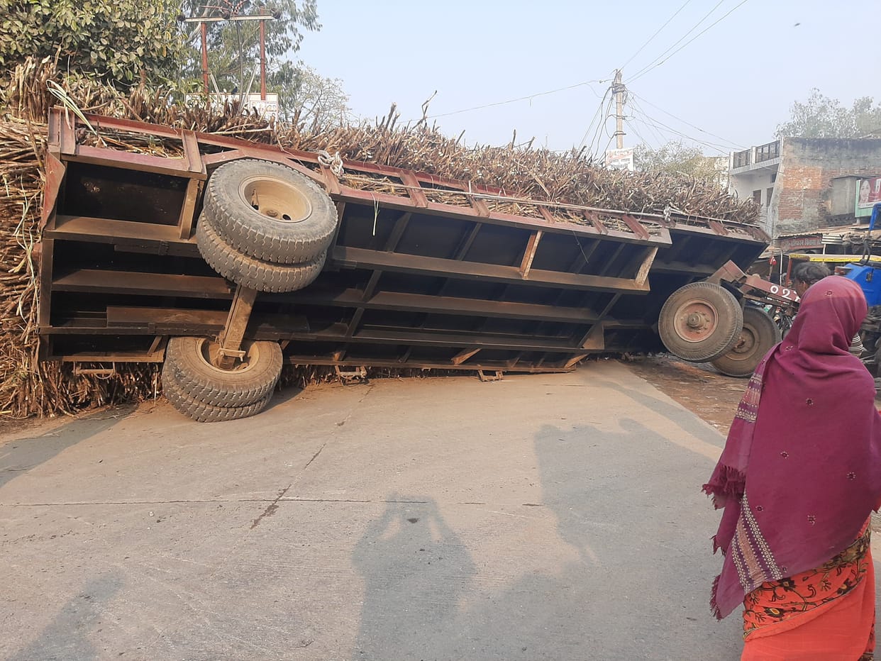 Sugarcane-loaded trola overturned on the middle road