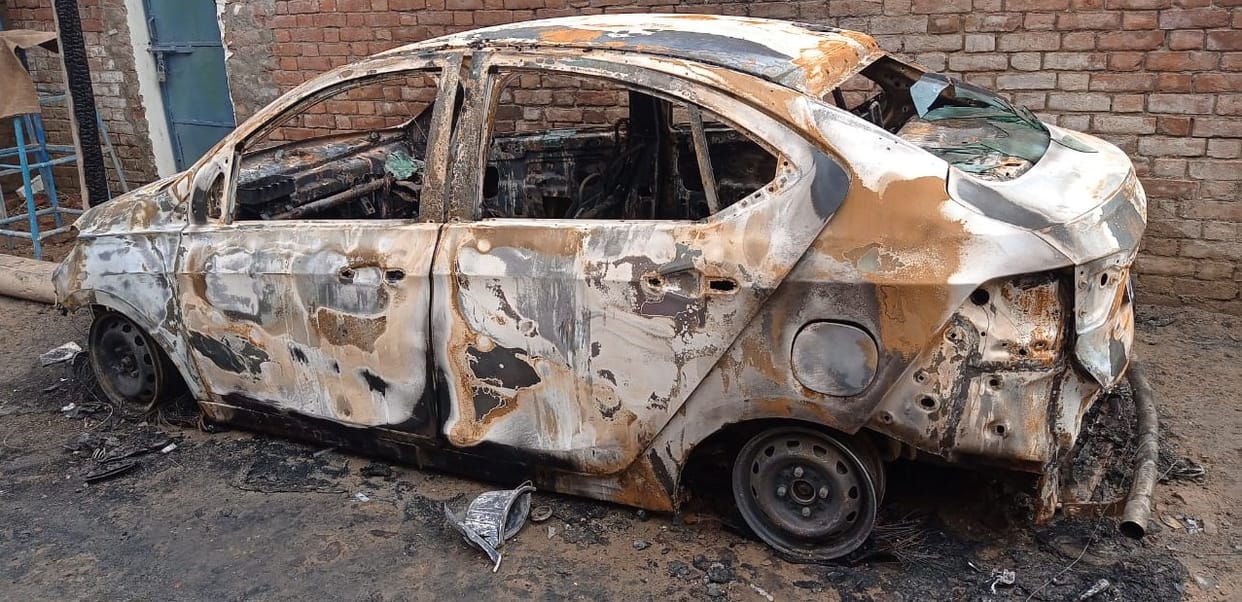 Suspected recently burnt car, police engaged in investigation