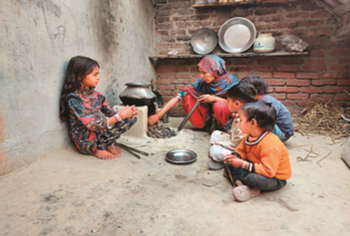 आंबेडकरनगर गांव की अमरवती अपने अतिकुपोषित बच्ची संजना व अन्य बच्चों के लिए खाना पकाते हुए