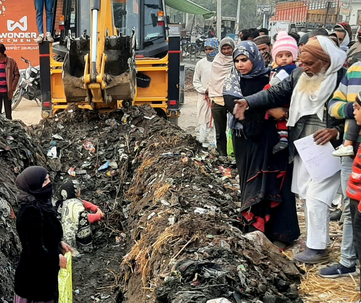 Late women stopped construction work in front of JCB