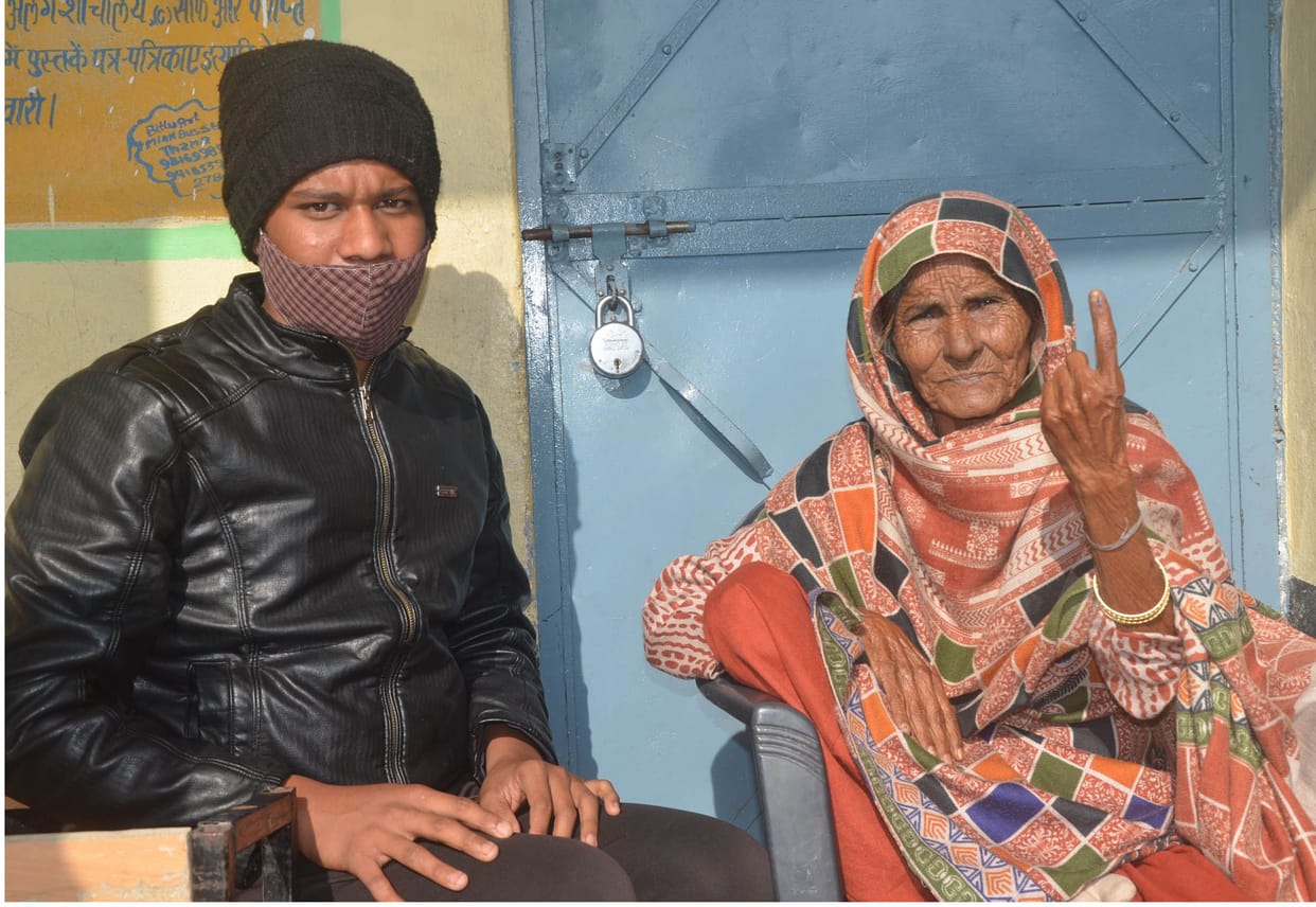 youth and old man cast their vote