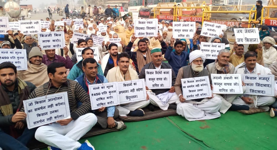 Farmers protested by putting posters around their neck