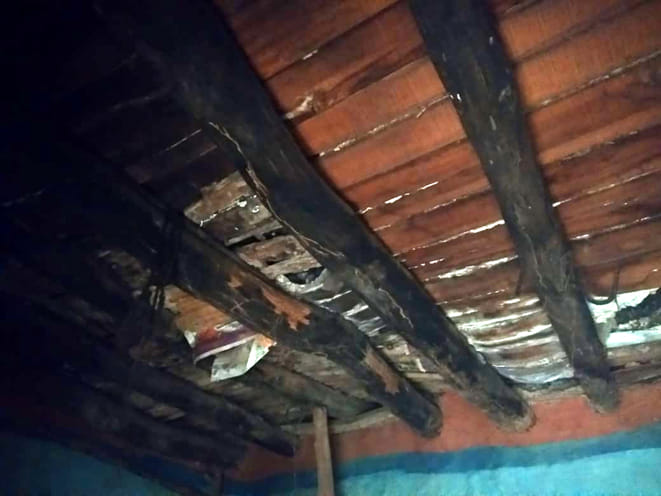 The wall collapses, two dead sisters buried under debris