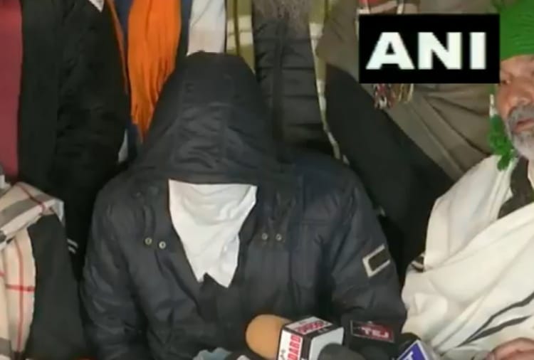 Farmers present a person who alleges a plot to shoot four farmer leaders and cause disruption