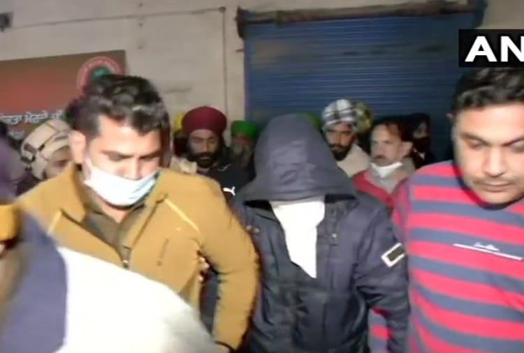 Farmers present a person who alleges a plot to shoot four farmer leaders and cause disruption
