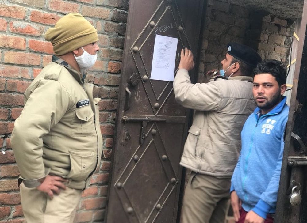 Notice of attachment attached to absconding accused's house