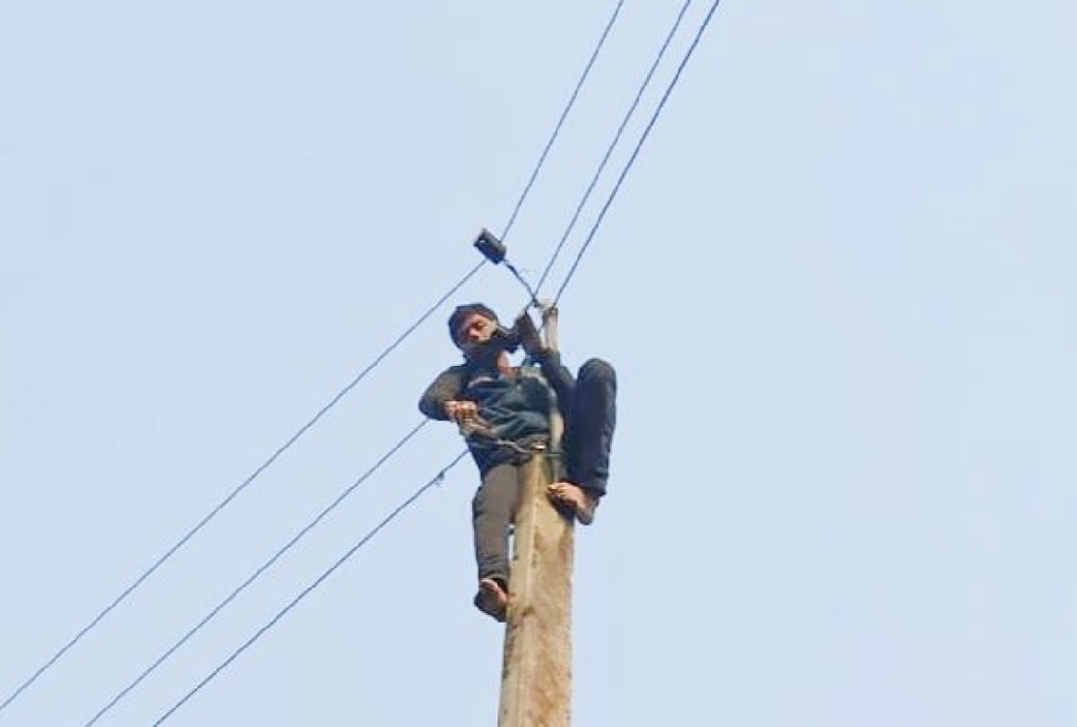 young man climbed on electric pole in one side love