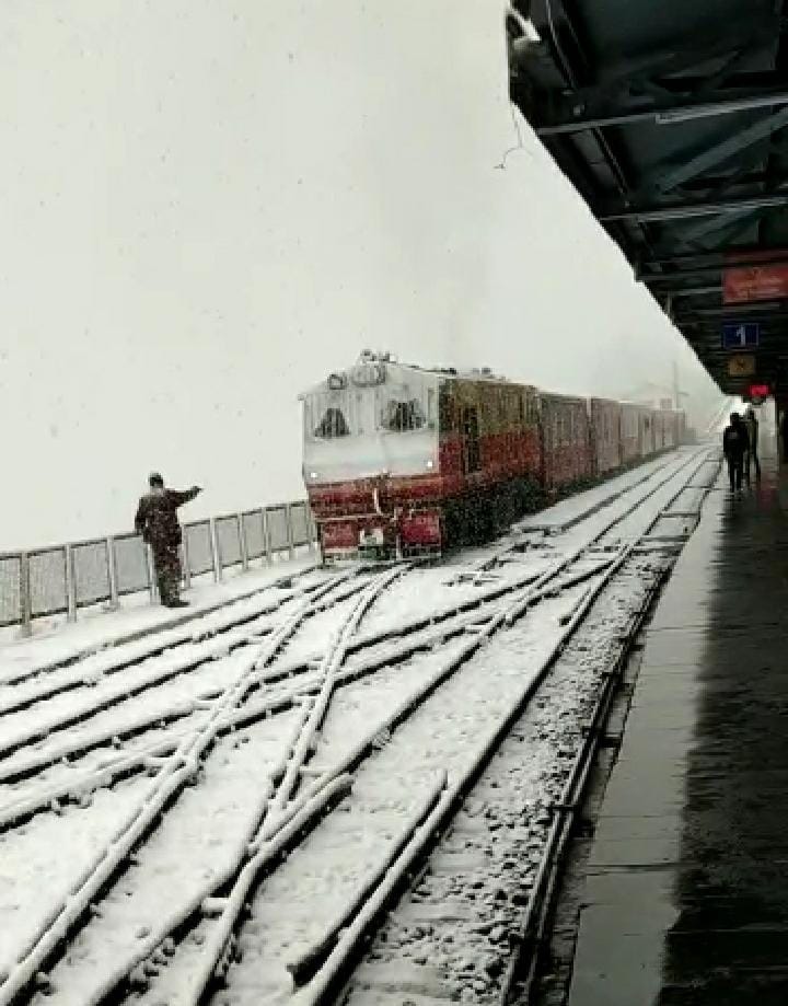 Toy trains runing in snowfall