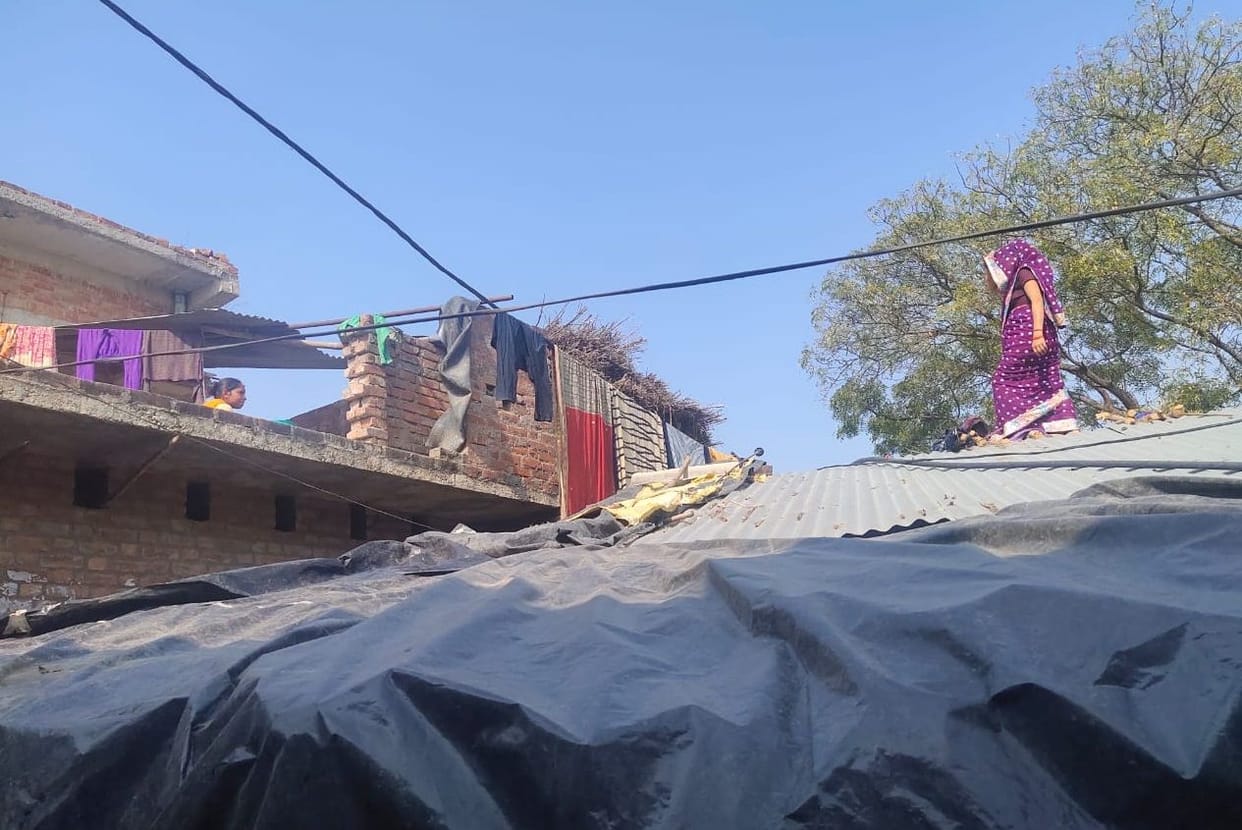 People drying clothes on LT power line in Ladhupura
