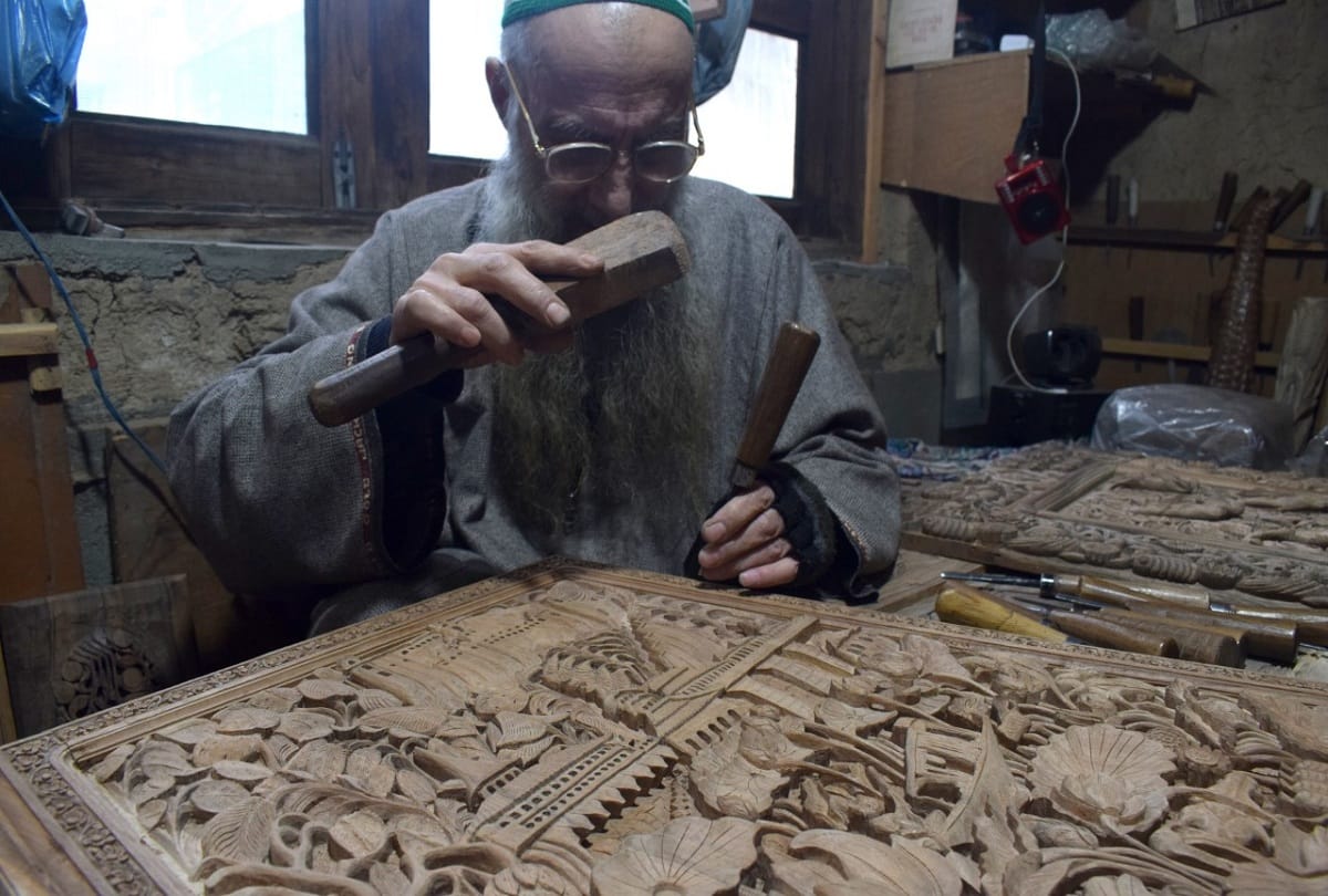 kashmiri artisan Ghulam nabi dar carves wood to make designs in downtown Srinagar walnut wood carving