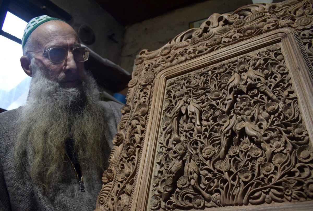 kashmiri artisan Ghulam nabi dar carves wood to make designs in downtown Srinagar walnut wood carving