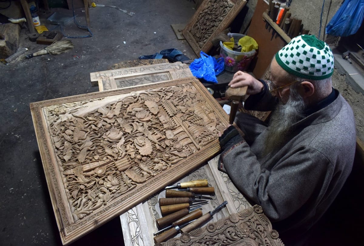 kashmiri artisan Ghulam nabi dar carves wood to make designs in downtown Srinagar walnut wood carving