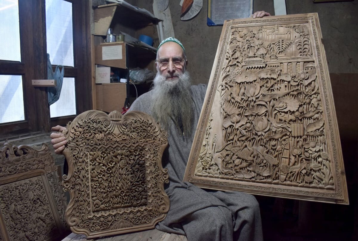 kashmiri artisan Ghulam nabi dar carves wood to make designs in downtown Srinagar walnut wood carving