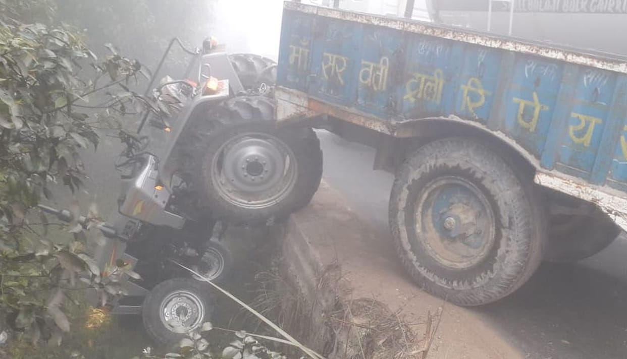 Pickup overturned in accident, tractor hangs from culvert