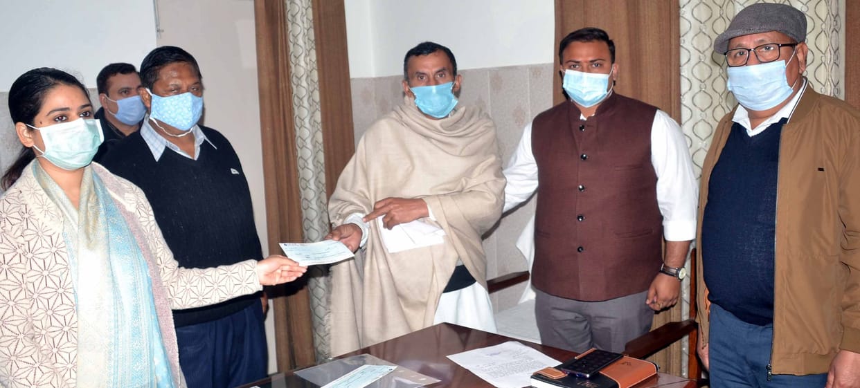 DM distributed checks to the needy