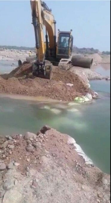 village,police,JCB,river,DM