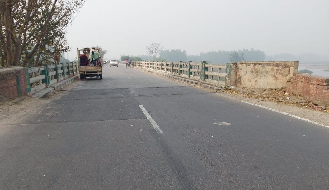 Patch of shabby bridges on gleaming road