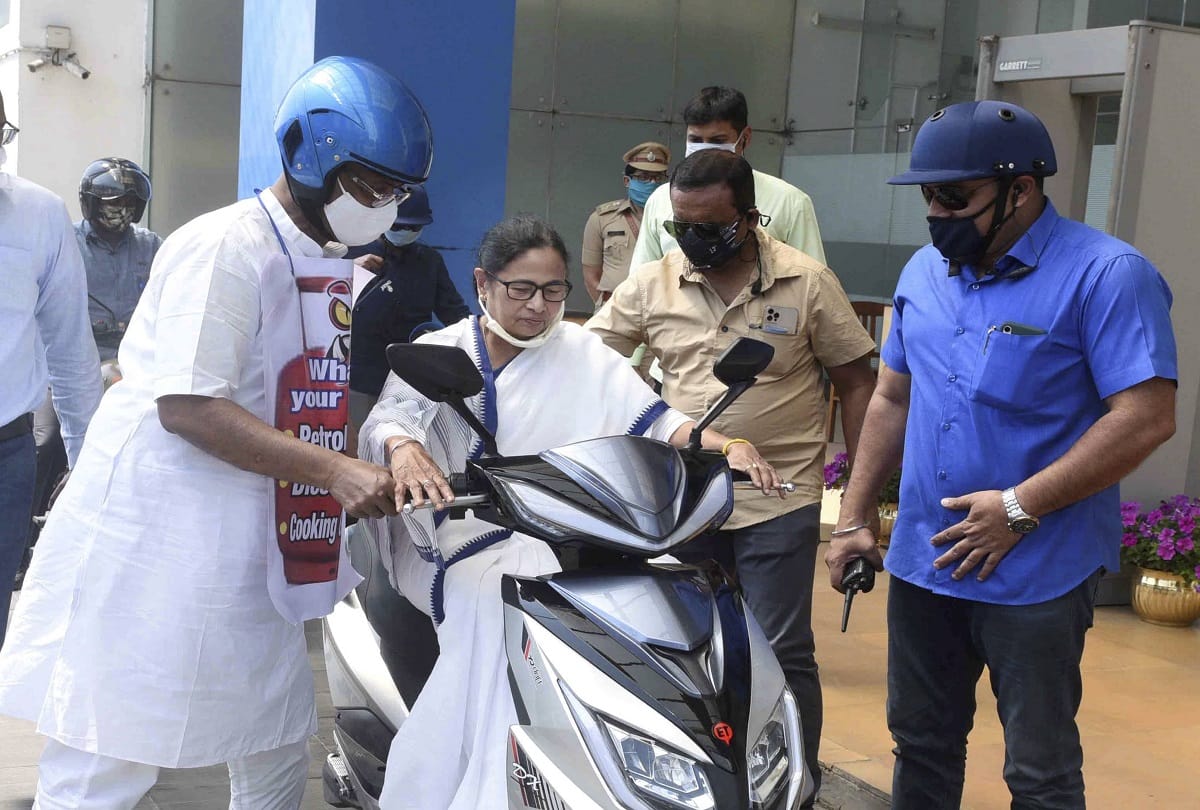 west bengal cm mamata banerjee nearly falls while driving an electric scooter in howrah, protest against fuel price hike