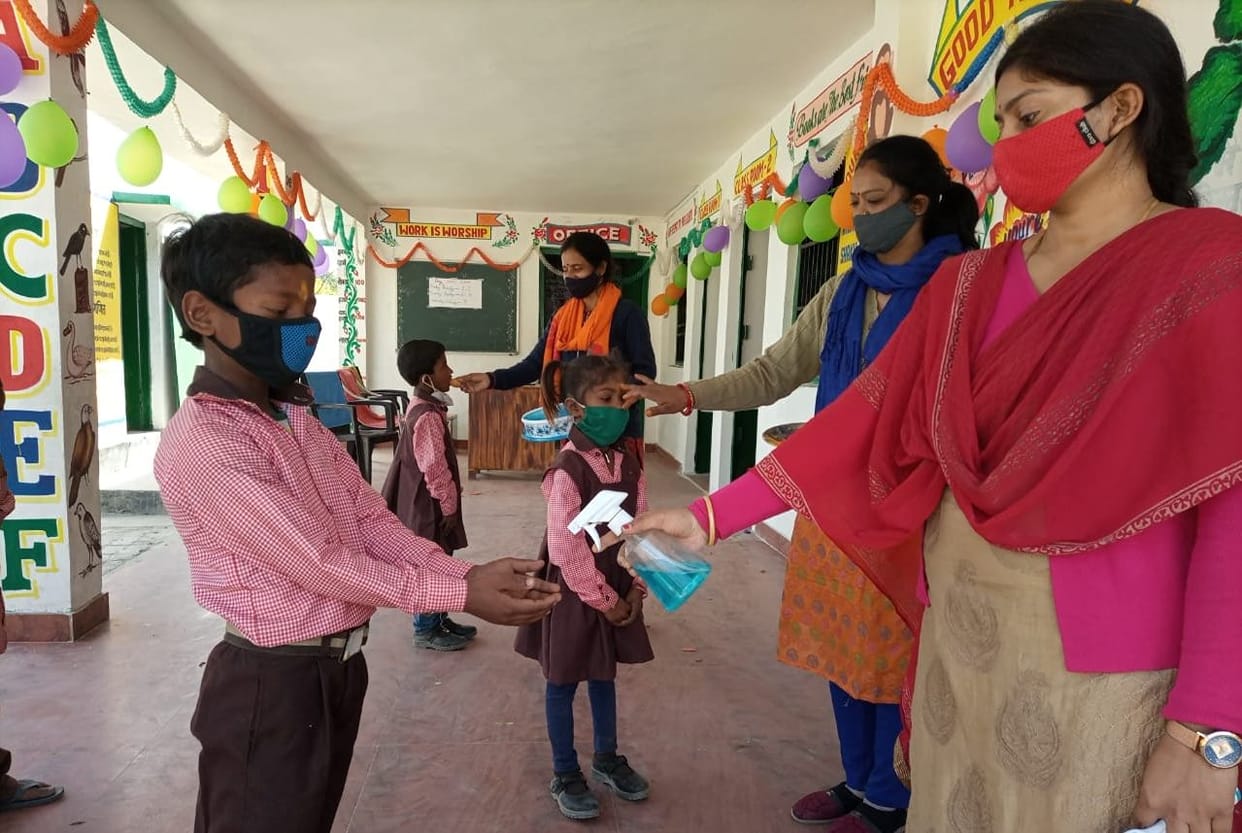 Children fed sweets by applying tilak
