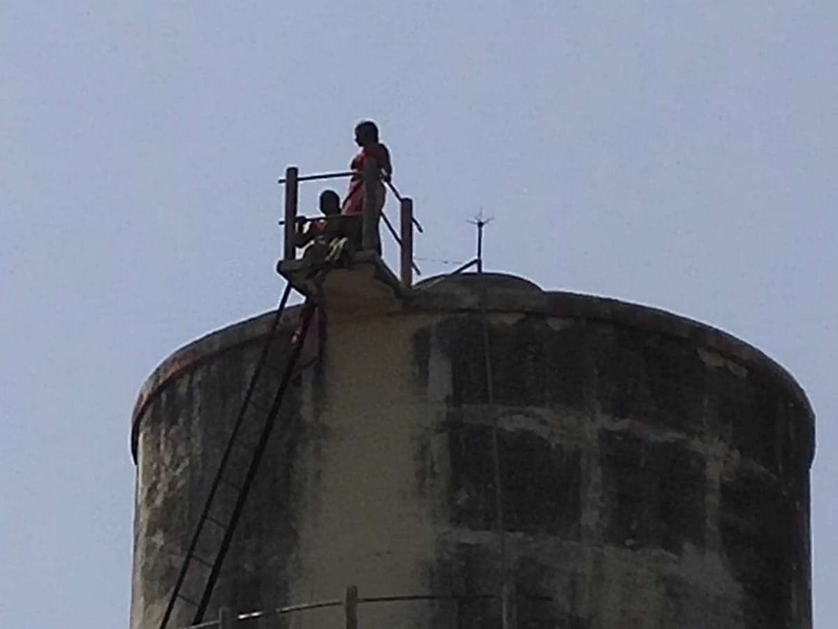 Two real sister climb on water tank for not getting possession of land in bhadohi up