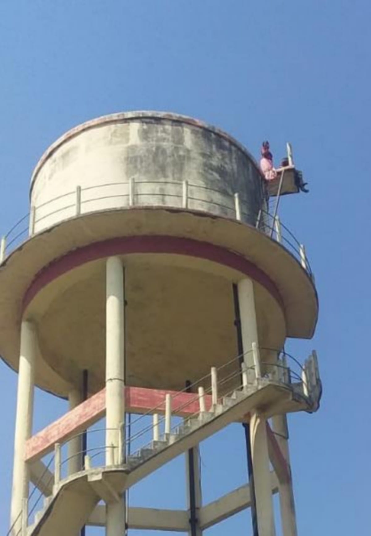 Two real sister climb on water tank for not getting possession of land in bhadohi up