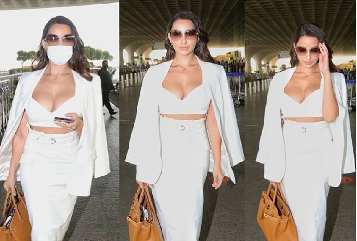 nora fatehi hot formal look in three piece set white crop top with skirt at mumbai airport