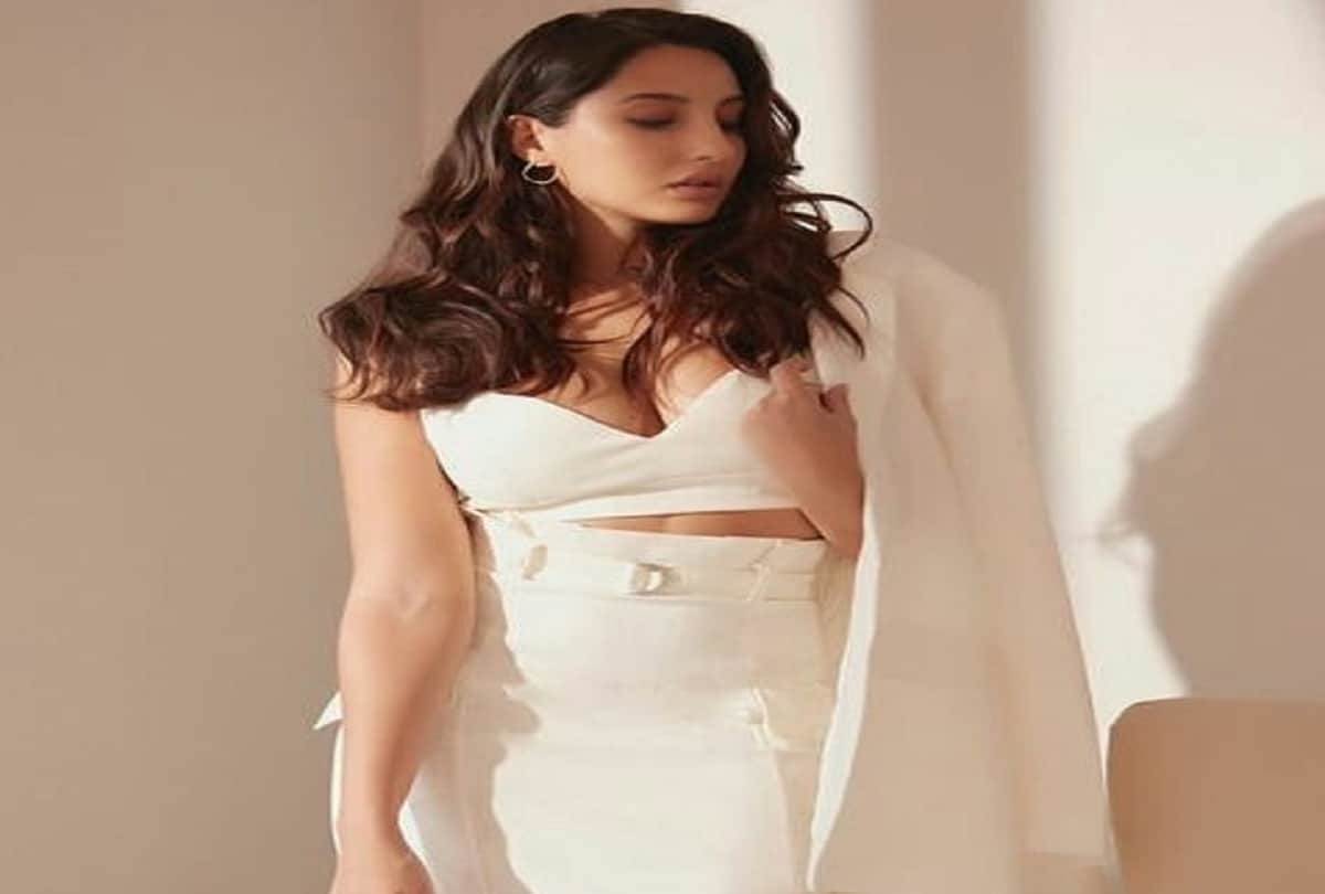 nora fatehi hot formal look in three piece set white crop top with skirt at mumbai airport