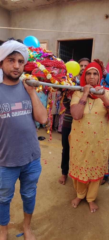 In village Risalia Kheda, daughters and grandchildren shoulder the woman's bier