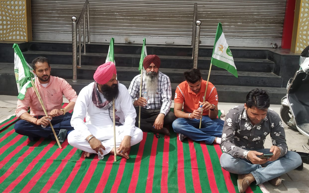 Farmers sitting on strike holding Reliance showroom closed