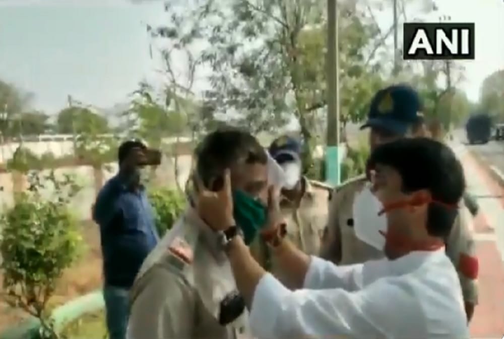 BJP leader Jyotiraditya Scindia provides first aid to one Police personnel who fell down from the vehicles 