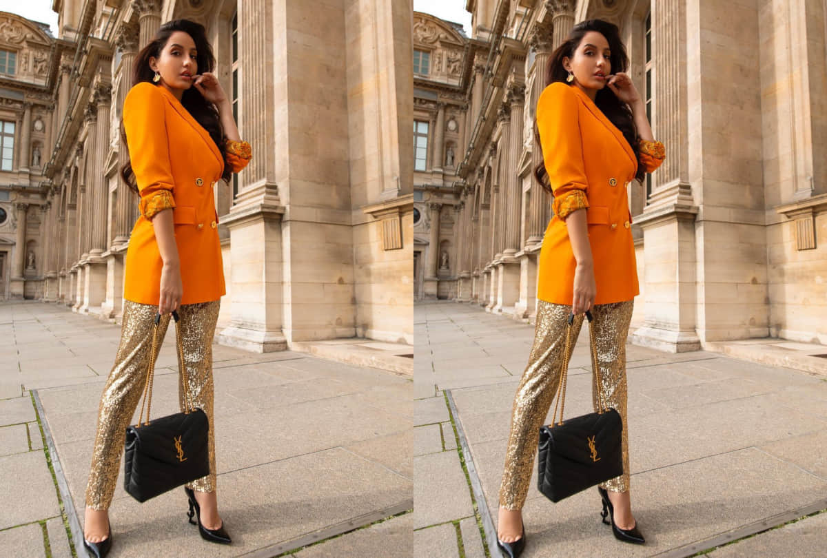 nora fatehi look splendid in orange blazer with golden shimmer pants