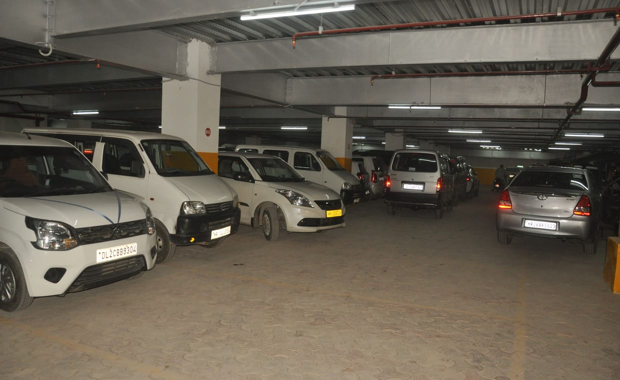 Underground parking filled with cars, two-wheelers still in markets, three floors of parking empty