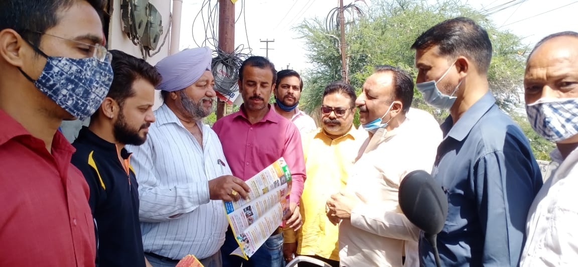 Giving information about four years of government work by distributing leaflets