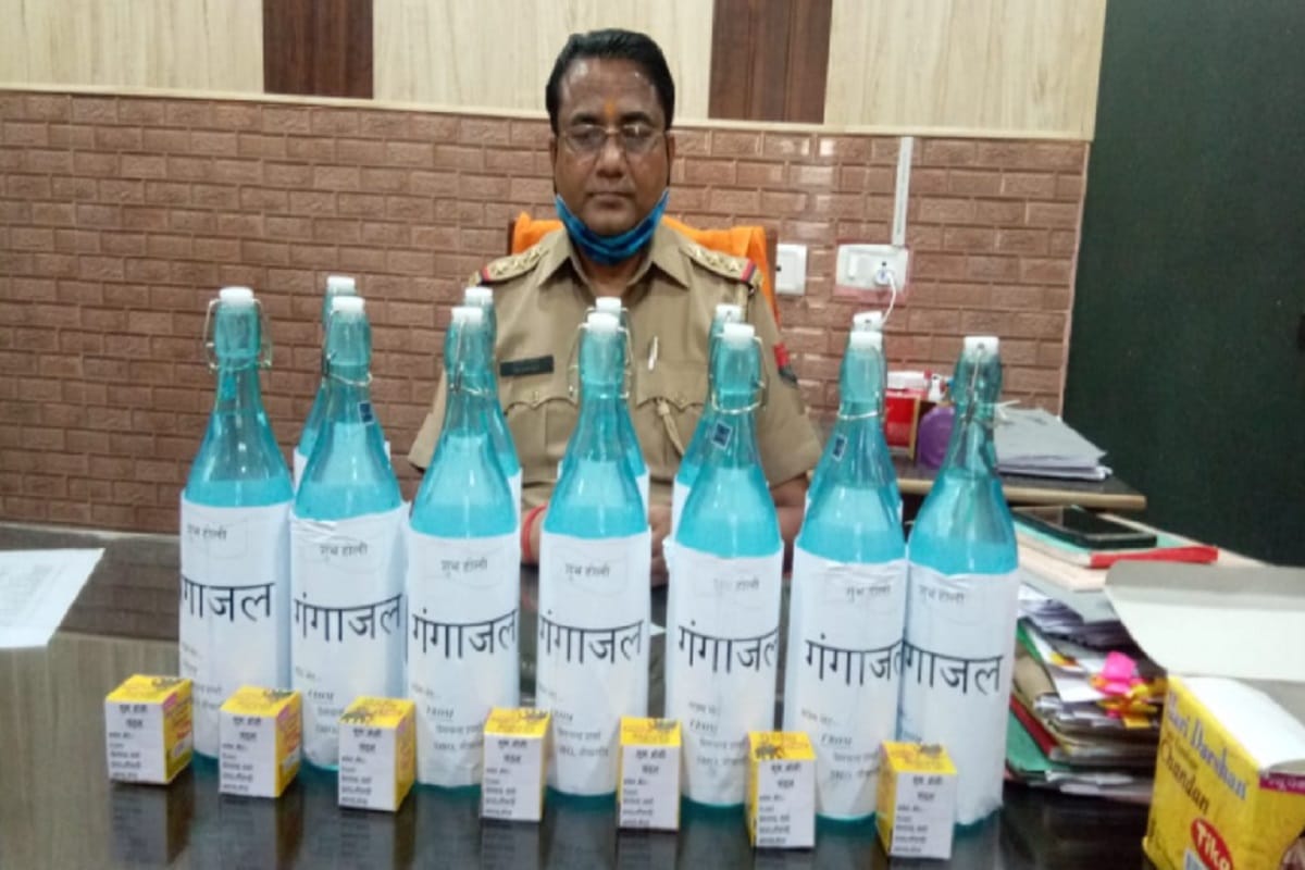 Inspector Premchand Sharma distributed bottle of Ganga water to the policemen on the day of Holi in Meerut