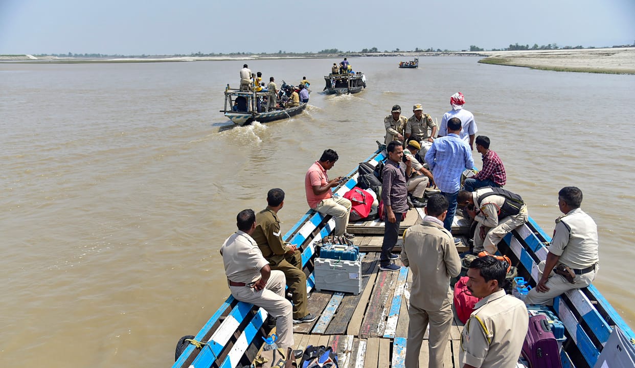 Polling parties taking the EVM and other election material to the remote areas from boats on the eve of the third phase of assam assembly elections in Kamrup