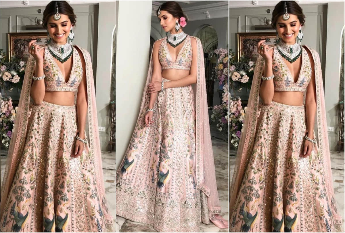 tara sutaria in anita dongre floral pink lehenga with low cut neckline blouse shows her toned midriff