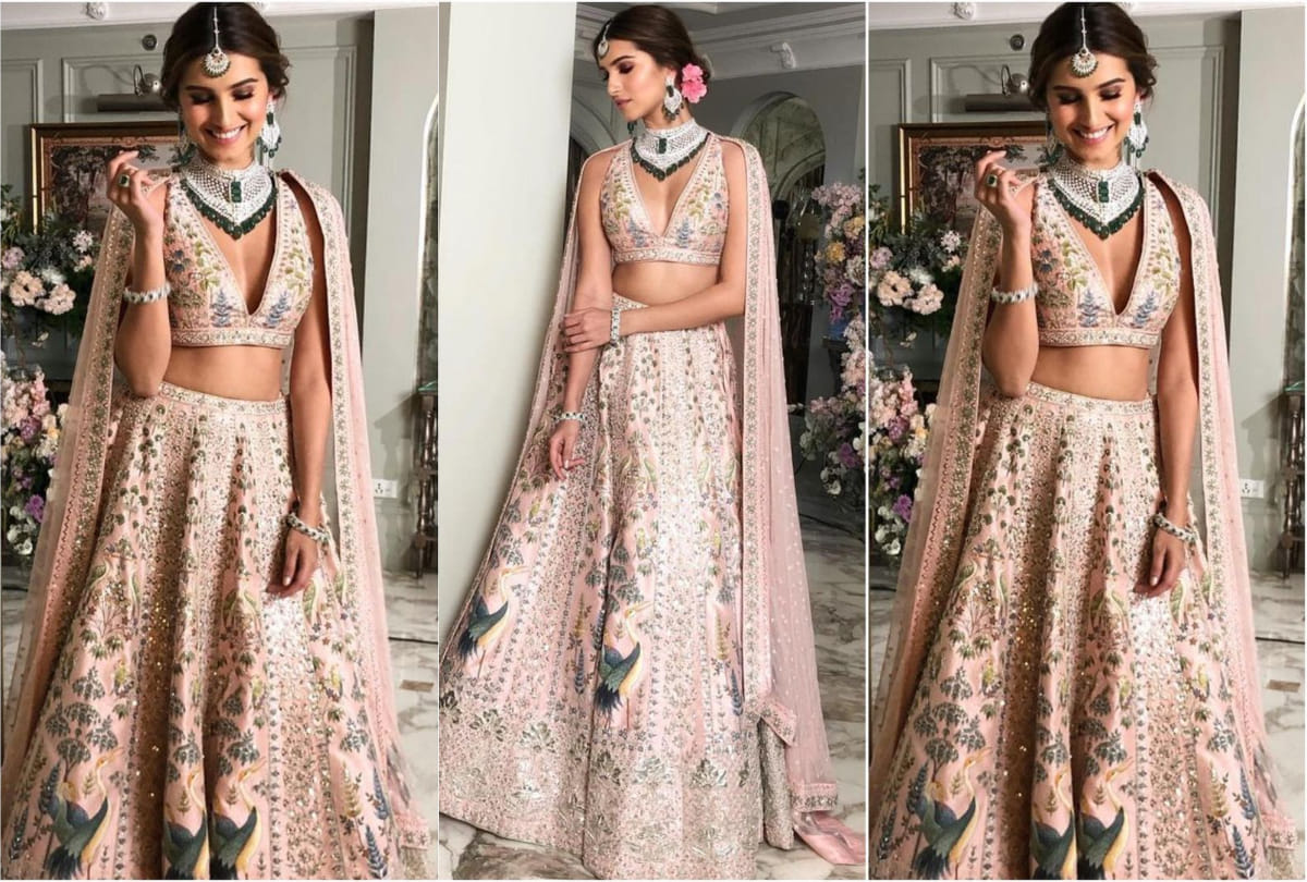 tara sutaria in anita dongre floral pink lehenga with low cut neckline blouse shows her toned midriff