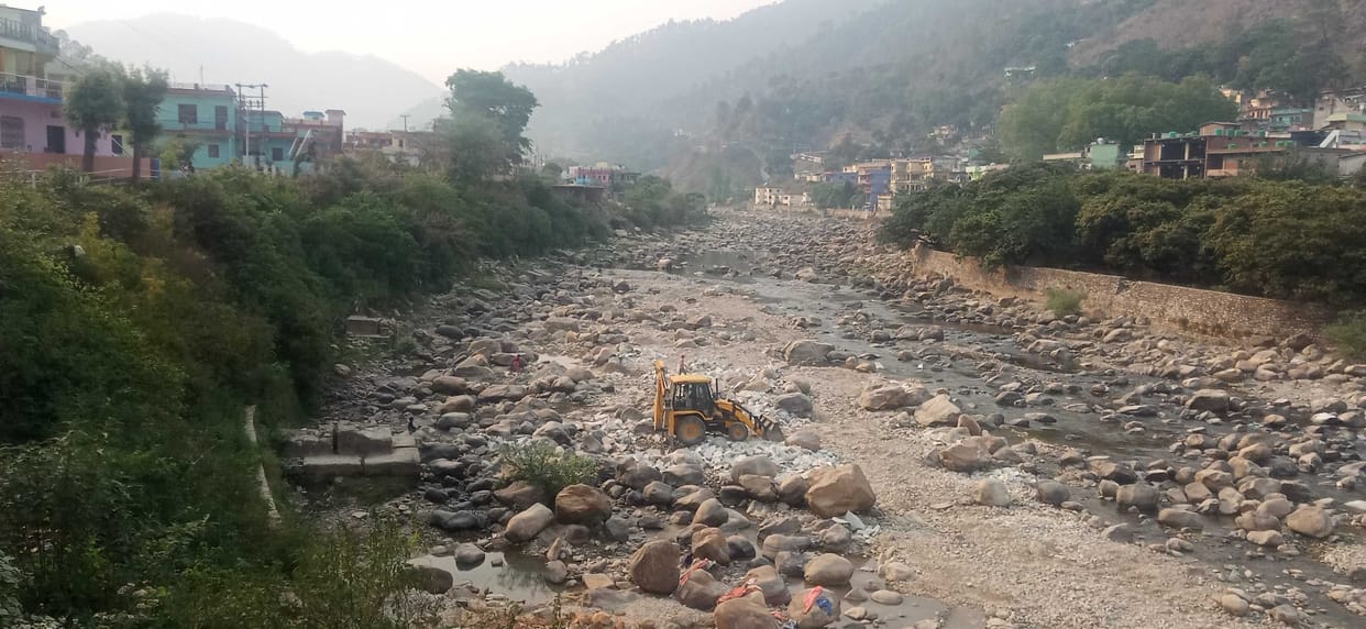 Boulders are being broken by planting JCB in Gomti river