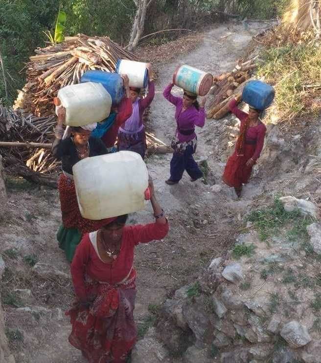Women quenching the family's thirst by carrying water on their heads