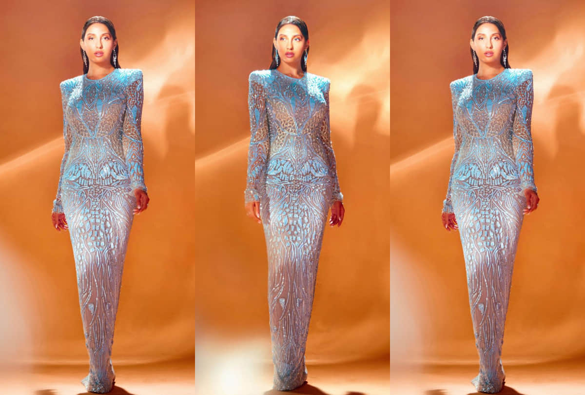 nora fatehi flaunts curvy body in silver shimmery dress