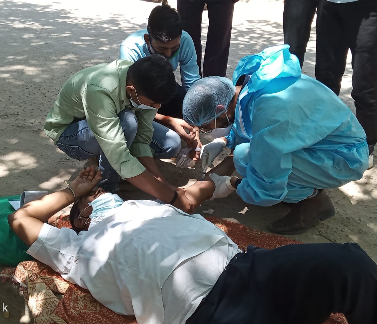 Security guards lie down at the gate of the hospital for treatment