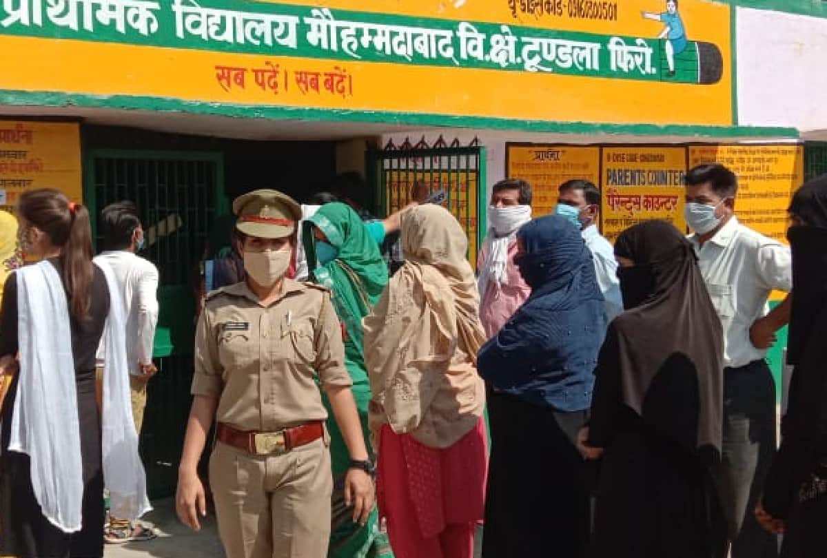 Voters queue outside polling booths as voting for panchayat elections is firozabad